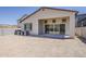 Backyard of a tan home featuring a covered patio and desert landscaping with mountain views at 21276 W Mariposa St, Buckeye, AZ 85396