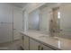 Bathroom featuring a wide mirror, white vanity, and a tiled shower with a glass door at 21276 W Mariposa St, Buckeye, AZ 85396