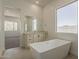 Luxury bathroom with soaking tub, vanity, and bright natural light at 21276 W Mariposa St, Buckeye, AZ 85396