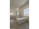 Bright bathroom with a freestanding tub, vanity, and large window showcasing natural light at 21276 W Mariposa St, Buckeye, AZ 85396
