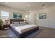 Comfortable bedroom featuring a king bed, soft rug, and ensuite bathroom at 21276 W Mariposa St, Buckeye, AZ 85396