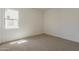 Bright bedroom with a large window, neutral carpet, and fresh paint at 21276 W Mariposa St, Buckeye, AZ 85396