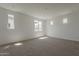 Bright and airy bedroom with neutral carpet and multiple windows offering great natural light at 21276 W Mariposa St, Buckeye, AZ 85396