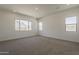 Bright bedroom with carpet and large windows providing natural light and views at 21276 W Mariposa St, Buckeye, AZ 85396