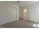 Bedroom with closet doors leading to ensuite bathroom featuring double sink at 21276 W Mariposa St, Buckeye, AZ 85396