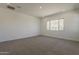 Bedroom featuring plush carpet and large window with mountain views at 21276 W Mariposa St, Buckeye, AZ 85396