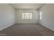 Bright bedroom with carpet, ample natural light, and mountain views at 21276 W Mariposa St, Buckeye, AZ 85396