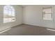 Bright, airy bedroom featuring large arch window and neutral walls at 21276 W Mariposa St, Buckeye, AZ 85396