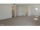 Spacious carpeted bedroom with multiple doorways and windows, offering lots of room at 21276 W Mariposa St, Buckeye, AZ 85396