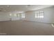Upstairs bonus room with neutral carpet, windows, and recessed lighting at 21276 W Mariposa St, Buckeye, AZ 85396