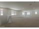 Upstairs bonus room with neutral carpet, windows, and recessed lighting at 21276 W Mariposa St, Buckeye, AZ 85396