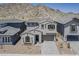 Beautiful two-story home features a paved driveway and well-maintained desert landscaping at 21276 W Mariposa St, Buckeye, AZ 85396