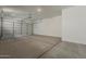 Spacious garage with sealed concrete flooring and a roll-up door for vehicle parking at 21276 W Mariposa St, Buckeye, AZ 85396