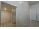 Hallway featuring patterned tile flooring that leads into a room and entryway at 21276 W Mariposa St, Buckeye, AZ 85396
