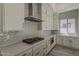 Modern kitchen featuring white cabinets, subway tile backsplash, stainless steel appliances, and quartz countertops at 21276 W Mariposa St, Buckeye, AZ 85396