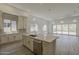 Bright, open kitchen with island, stainless steel appliances, and seamless access to the living room at 21276 W Mariposa St, Buckeye, AZ 85396