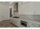 Well-appointed kitchen featuring gas range, built-in microwave, and sleek white cabinets at 21276 W Mariposa St, Buckeye, AZ 85396
