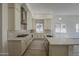 Stylish kitchen with white cabinets, stainless steel appliances and island with sink at 21276 W Mariposa St, Buckeye, AZ 85396