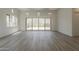 Bright living room with walls of windows and wood floors at 21276 W Mariposa St, Buckeye, AZ 85396