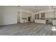 Expansive living room with built-in cabinets, neutral palette, and wood flooring at 21276 W Mariposa St, Buckeye, AZ 85396