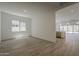 Large, brightly lit living room features wood floors and an open-concept layout at 21276 W Mariposa St, Buckeye, AZ 85396