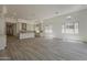 Open living area with wood floors, recessed lighting, and kitchen view at 21276 W Mariposa St, Buckeye, AZ 85396