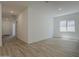 Spacious, brightly lit living room features wood floors and recessed lighting at 21276 W Mariposa St, Buckeye, AZ 85396