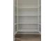 Walk-in pantry with white shelving and wood floors at 21276 W Mariposa St, Buckeye, AZ 85396