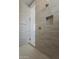 Sleek shower with neutral-toned tile, a rain shower head, and glass door at 21276 W Mariposa St, Buckeye, AZ 85396