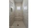 Modern shower with neutral tiles, a built-in bench, and a sleek rain shower head at 21276 W Mariposa St, Buckeye, AZ 85396