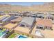 An aerial view of the home with a swimming pool and mountain views at 21427 W Meadowbrook Ave, Buckeye, AZ 85396