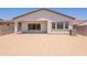 A view of the backyard with a covered patio and a sliding glass door at 21427 W Meadowbrook Ave, Buckeye, AZ 85396