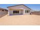 A view of the backyard with a covered patio and a sliding glass door at 21427 W Meadowbrook Ave, Buckeye, AZ 85396