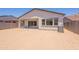 A view of the backyard showing the covered patio and neighboring homes at 21427 W Meadowbrook Ave, Buckeye, AZ 85396