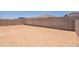 The backyard area is enclosed with a tall block wall for privacy at 21427 W Meadowbrook Ave, Buckeye, AZ 85396