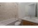 Tiled bathroom with tub shower, updated cabinets, and chrome fixtures at 21427 W Meadowbrook Ave, Buckeye, AZ 85396