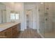 Bathroom featuring double sinks with quartz counters and glass shower at 21427 W Meadowbrook Ave, Buckeye, AZ 85396