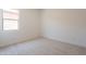 Well-lit bedroom with carpet flooring and a window with a neighborhood view at 21427 W Meadowbrook Ave, Buckeye, AZ 85396