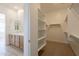 Walk-in closet with built-in shelving, adjacent to the bathroom at 21427 W Meadowbrook Ave, Buckeye, AZ 85396