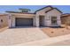 Inviting single-story home with a two-car garage, desert landscaping, and a paved driveway in a quiet neighborhood at 21427 W Meadowbrook Ave, Buckeye, AZ 85396