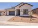 Charming single-story home featuring a two-car garage and desert landscaping in a peaceful residential neighborhood at 21427 W Meadowbrook Ave, Buckeye, AZ 85396