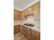 Close-up of a kitchen featuring wood cabinets, quartz countertops, a subway tile backsplash, and a gas cooktop at 21427 W Meadowbrook Ave, Buckeye, AZ 85396
