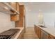 Well-equipped kitchen features wood cabinets, quartz countertops, a subway tile backsplash, and stainless steel appliances at 21427 W Meadowbrook Ave, Buckeye, AZ 85396