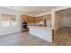 Stylish kitchen with a large island, light wood cabinets, and stainless steel appliances at 21427 W Meadowbrook Ave, Buckeye, AZ 85396