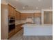 Modern kitchen featuring light wood cabinetry, a large island, and stainless steel appliances at 21427 W Meadowbrook Ave, Buckeye, AZ 85396