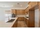 Modern kitchen with wood cabinets, quartz countertops, subway tile backsplash, and stainless steel appliances at 21427 W Meadowbrook Ave, Buckeye, AZ 85396