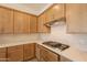 A well-equipped kitchen features wood cabinets, quartz countertops, a subway tile backsplash, and stainless steel appliances at 21427 W Meadowbrook Ave, Buckeye, AZ 85396