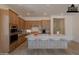 Bright, staged kitchen boasts a large island with bar seating, stainless steel appliances, and warm wood cabinets at 21427 W Meadowbrook Ave, Buckeye, AZ 85396