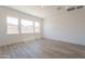 Bright living room with tile floors, recessed lighting, and three windows at 21427 W Meadowbrook Ave, Buckeye, AZ 85396