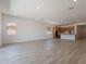 Expansive living area showcasing an open layout with light-filled windows and wood-style tile at 21427 W Meadowbrook Ave, Buckeye, AZ 85396